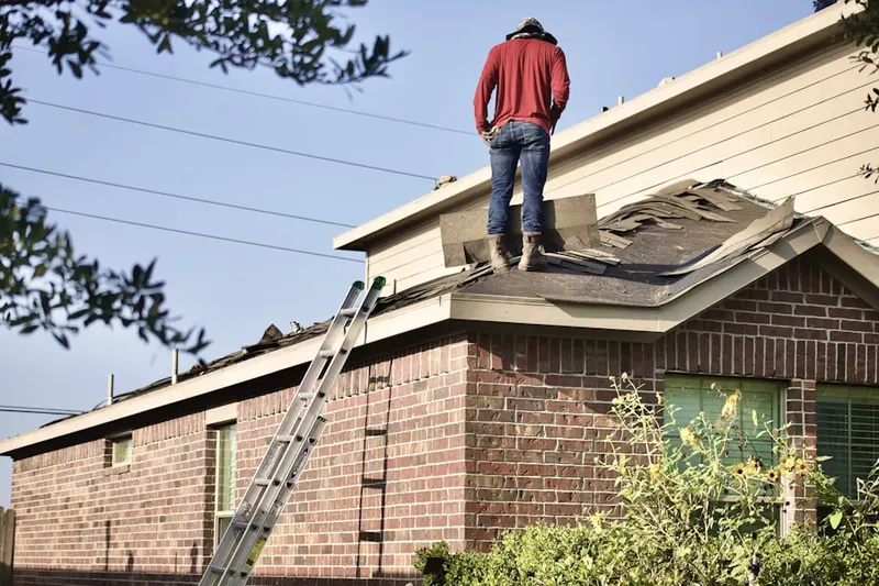 Professional roofer working on a residential roof in Giesboro
